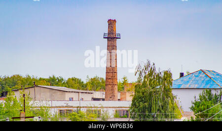 Plant with a chimney on the nature. Industrial landscape. Stock Photo