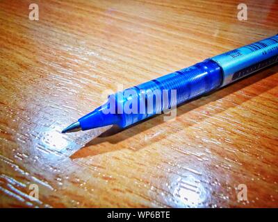 blue ball pen macro detailed image placed on a desk table Stock Photo
