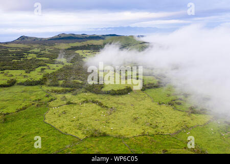 Aerial image of typical volcanic caldeira landscape with volcano cones of Planalto da Achada central plateau of Ilha do Pico Island, Azores Stock Photo