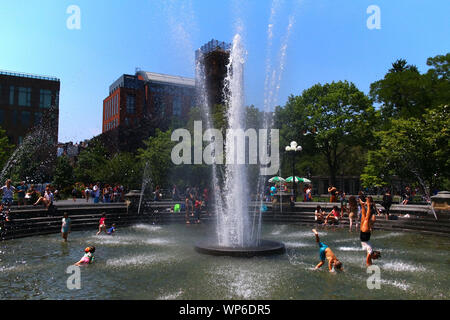 People enjoying hot summer day in Washington Square Park fountain in Manhattan on JULY 19th, 2019 in New York, USA. (Photo by Wojciech Migda) Stock Photo