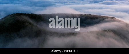 Aerial image with magical sunset over a low cloud layer covering Pico Island, with Ponta do Pico (Mount Pico), the highest mountain of Portugal coming Stock Photo