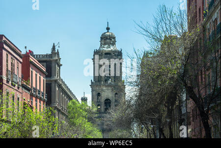 MEXICO CITY, MEXICO / MARCH 2 2019: La Catedral Bell Tower viewed from 5 de Mayo street, Metropolitan Cathedral of the Assumption of Mary of Mexico Ci Stock Photo