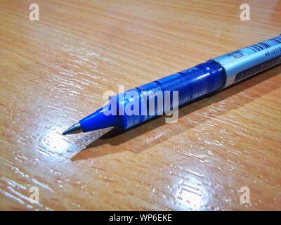 blue ball pen macro detailed image placed on a desk table Stock Photo