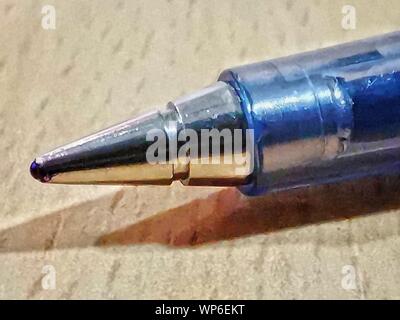 blue ball pen macro detailed image placed on a desk table Stock Photo