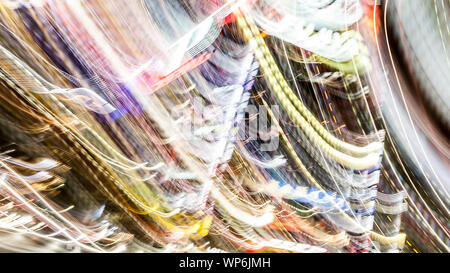 Defocused abstract electro multi colored lights. Festive bright background with gleaming effect and shiny bright neon glow Stock Photo