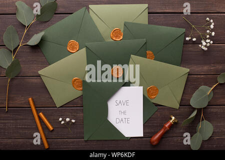 Composition of wedding envelopes with invitations on wood Stock Photo