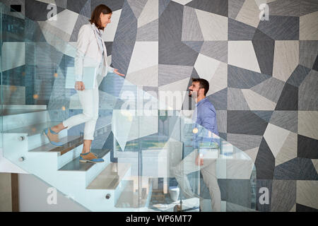 business concept: Smiling people walking up the stair Stock Photo
