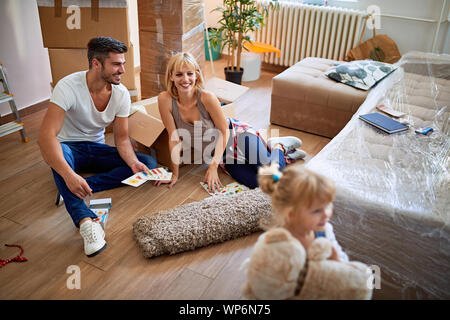 Funny moving to a new house – Happy parents moves boxes into a new house Stock Photo