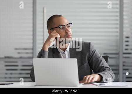 Thoughtful african american businessman thinking of problem solution. Stock Photo