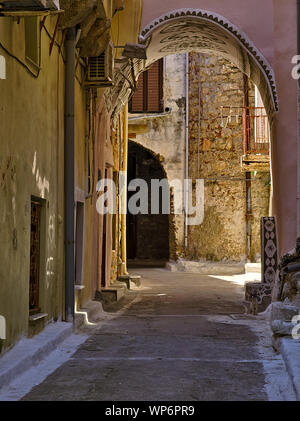 Narrow alley with decorated tunnel, in Pyrgi  medieval village, Chios island, Greece. Stock Photo