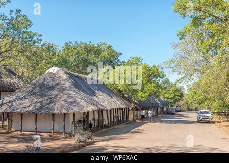 KRUGER NATIONAL PARK, SOUTH AFRICA - MAY 15, 2019: Bungalows in the Punda Maria Rest Camp. People and vehicles are visible Stock Photo