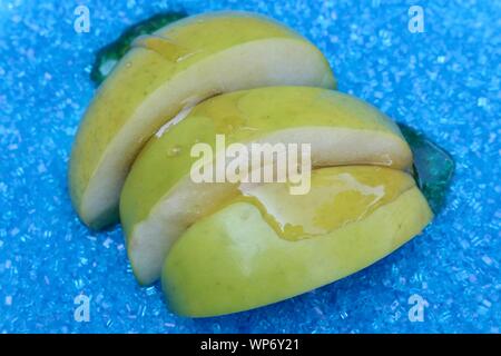 Apples dipped in honey for Rosh Hashana Stock Photo