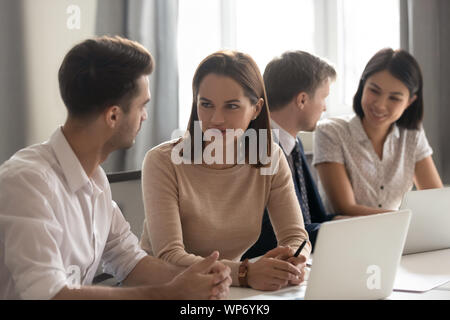 Concentrated employees working at coworking space in international company office. Stock Photo
