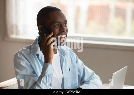 Smiling biracial man laugh having cellphone call Stock Photo