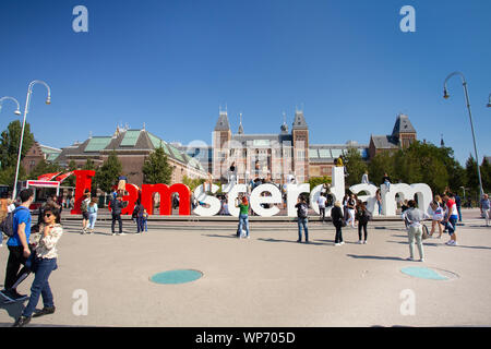 AMSTERDAM, NETHERLANDS - SEPTEMBER 2, 2018: View of visitors at the I Amsterdam sign with the historic Rijksmuseum in the background Stock Photo