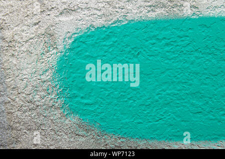 Green stripe with a brush on a gray wall - background texture Stock Photo