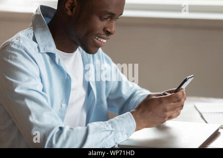 Smiling biracial man have pleasant chat on cellphone Stock Photo