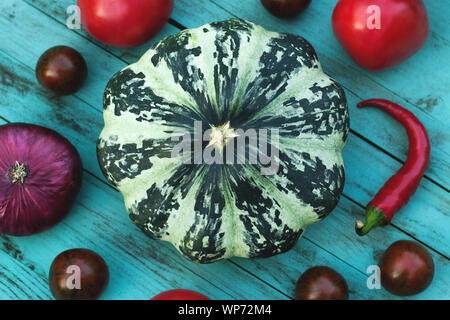 Still life with august harvest. Squash, tomatoes, chili peppers, onions on vintage wooden background. The concept of eco-friendly, organic vegetables, proper nutrition, vegetarianism Stock Photo