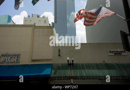 View of torn American flag and buildings in Historic District of Downtown Miami, Flagler Street, Miami, Florida, USA Stock Photo