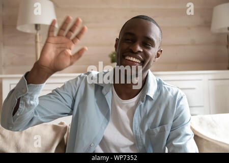 Smiling african American man wave having video call Stock Photo