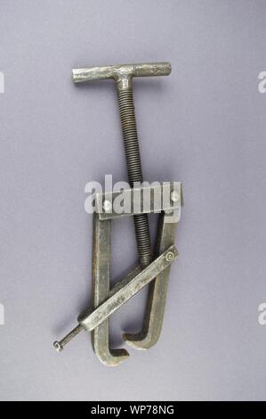 Metal bearing puller on a gray background with empty place for text. Stock Photo