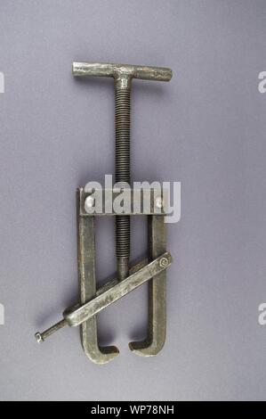 Metal bearing puller on a gray background with empty place for text. Stock Photo