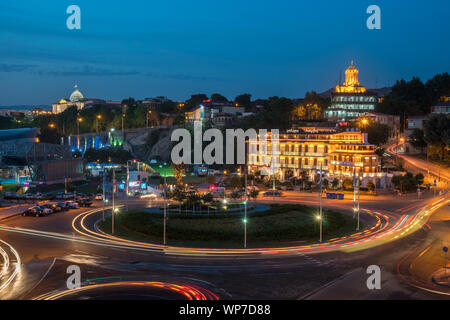 Tbilisi, Georgia - 30.08.2018: Night view over Europe square and Holy trinity Sameba church in the background. Travel. Stock Photo