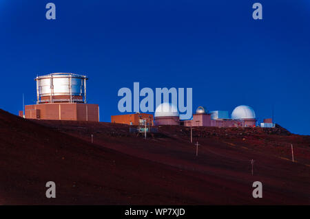 Space observatories with blue sky at sunrise on top of Haleakala Crater on Maui, Hawaii, USA Stock Photo