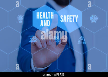 Text sign showing Health And Safety. Business photo text procedures intended to prevent accident in workplace Male human wear formal work suit present Stock Photo