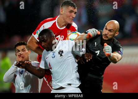 Belgrade. 7th Sep, 2019. Portugal's William Carvalho (C) vies with Serbia's goalkeeper Marko Dmitrovic (R) during the UEFA EURO 2020 Qualifying Round Group B match between Serbia and Portugal in Belgrade, Serbia on Sept. 7, 2019. Credit: Predrag Milosavljevic/Xinhua Stock Photo