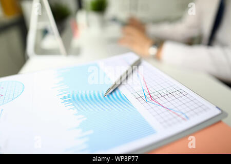 Silver pen lies on paper documents with color Stock Photo