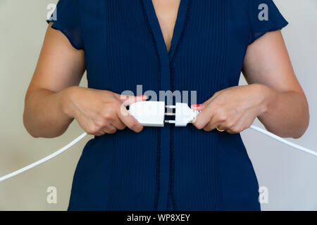 business woman connect two electrics cables Stock Photo
