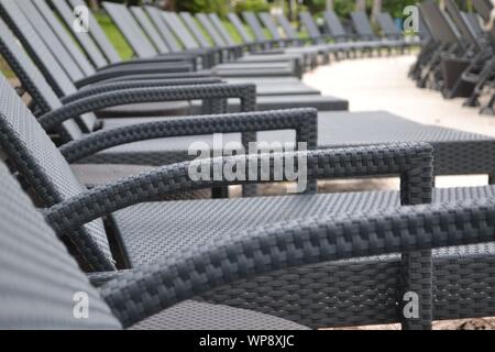 Long row of empty sun loungers neatly arranged in a line on a beach in Port Douglas, Queensland. Stock Photo