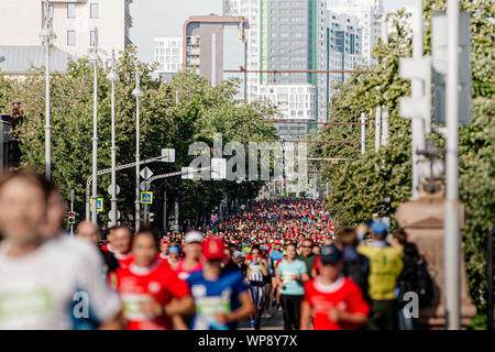Ekaterinburg, Russia - August 11, 2019: large group of runners athletes men and women run city street in Europe-Asia marathon Stock Photo