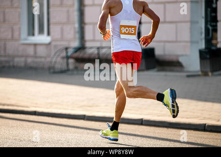 man athlete runner run marathon on city in soft sunlight Stock Photo