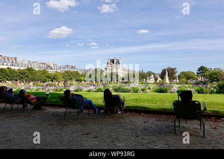 People relaxing in green chairs in the Tuileries Gardens, Paris, France Stock Photo