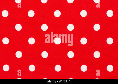 Red background with white polka dots pattern. Stock Photo