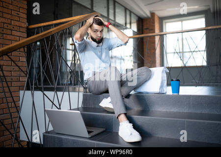 Freelancer feeling overloaded while having difficult task Stock Photo