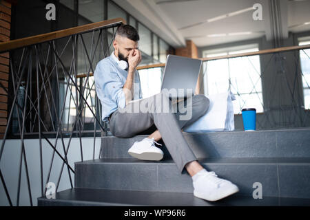 Freelancer feeling sleepy after working for too long Stock Photo