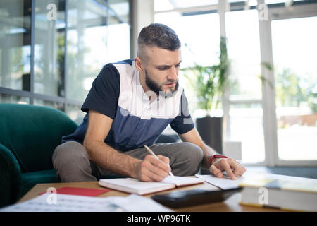 Freelancer feeling busy while working with documents Stock Photo
