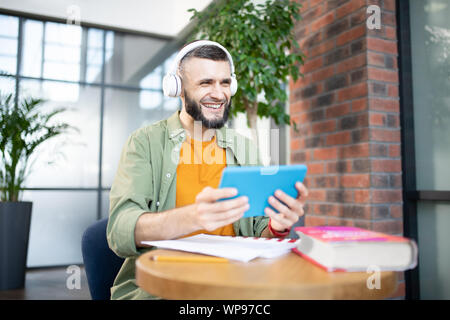 Cheerful handsome student feeling good while studying Stock Photo
