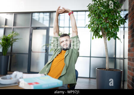 Bearded man feeling sleepy and tired after learning Stock Photo