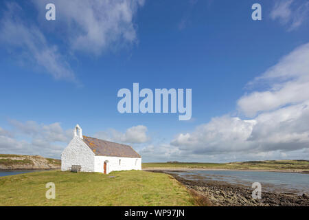 St. Cwyfan's church at Llangwyfan known as the Church in the Sea due to being cut off from the mainland at high tide, Anglesey, North Wales, UK Stock Photo