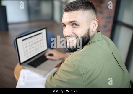 Top view of handsome man feeling motivated while working Stock Photo