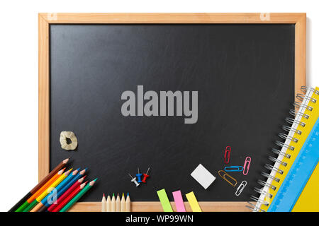 School and office supplies on blackboard background. Back to school concept with stationery supplies and chalkboard Stock Photo