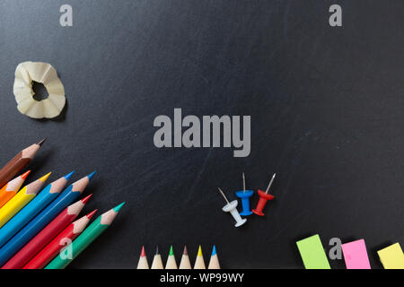 School and office supplies on blackboard background. Back to school concept with stationery supplies and chalkboard Stock Photo