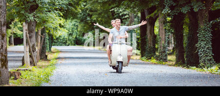 Young couple on retro scooter Stock Photo