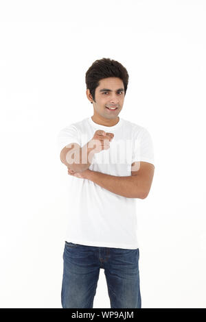 Young man pointing toward camera Stock Photo