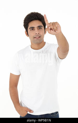 Young man pretending to work on touch screen Stock Photo