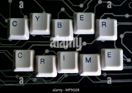 Keyboard keys form the word CYBER CRIME on black electric circuit in the background Stock Photo